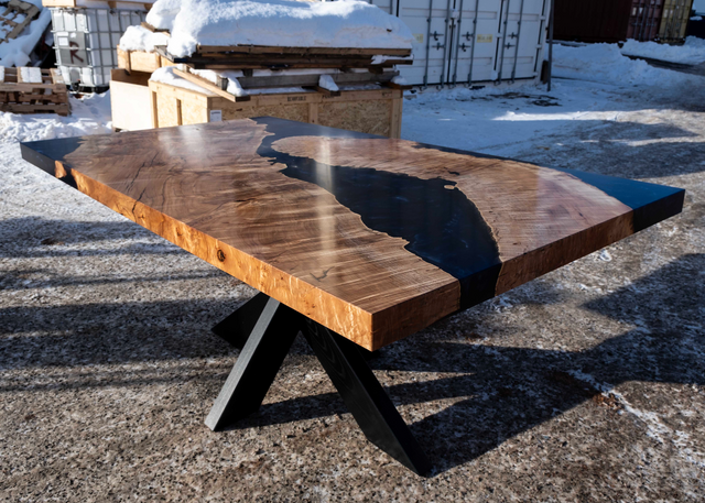 Wooden table with a river design on a snowy ground