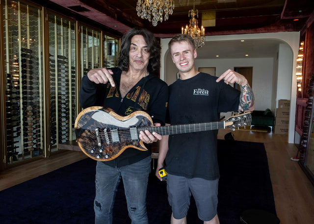 Paul Stanley Holding a Guitar with Dylan Thomas 