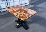 Wooden table with a unique grain pattern on a concrete surface