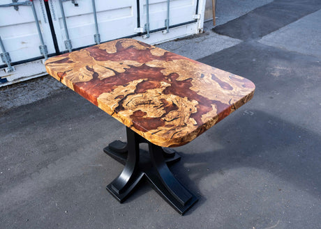 Wooden table with a unique grain pattern on a concrete surface